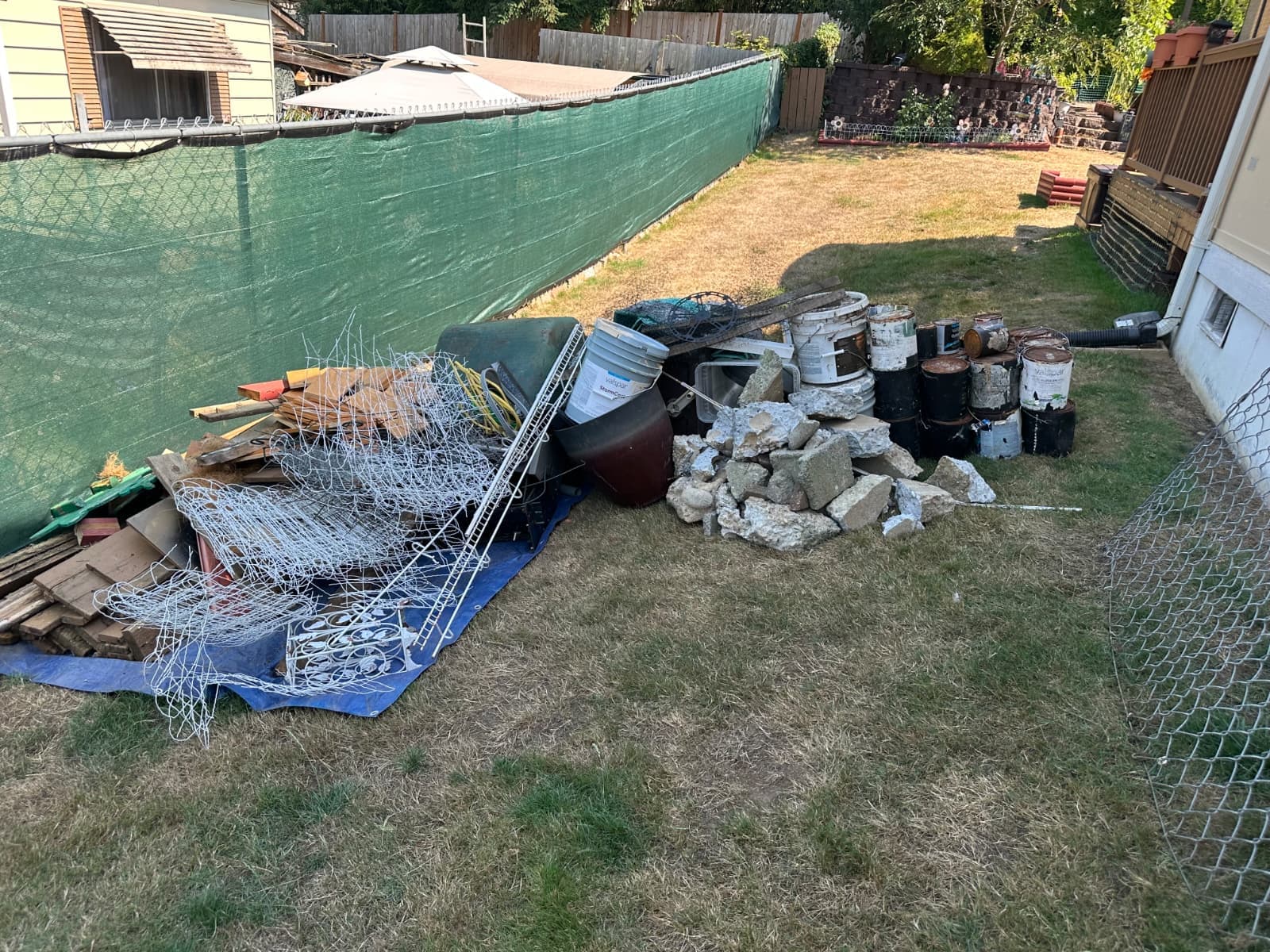 backyard of a house full of junk that is ready to be removed and hauled our and cleaned up